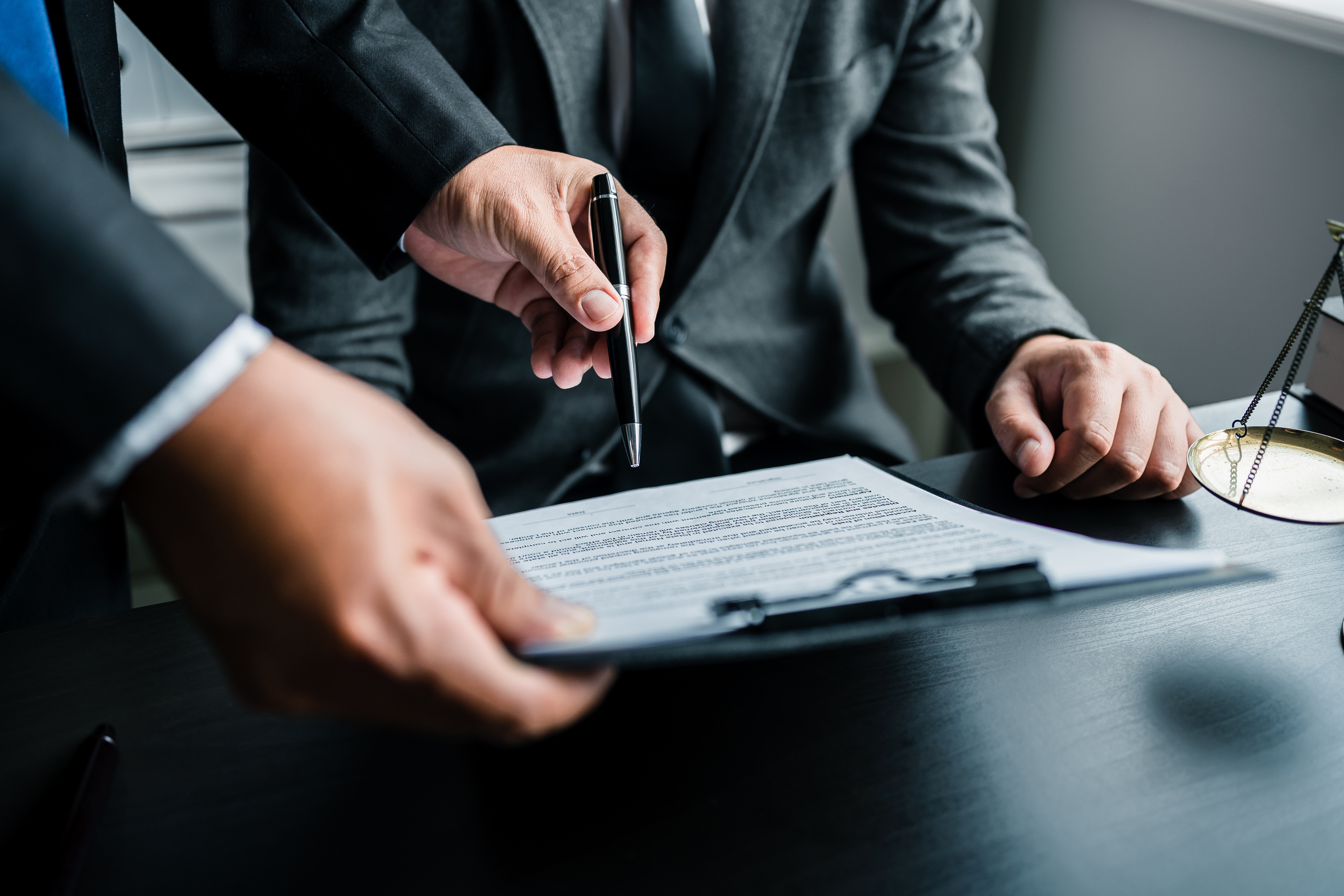 Close up of businessmen or lawyers discussing contract or busine